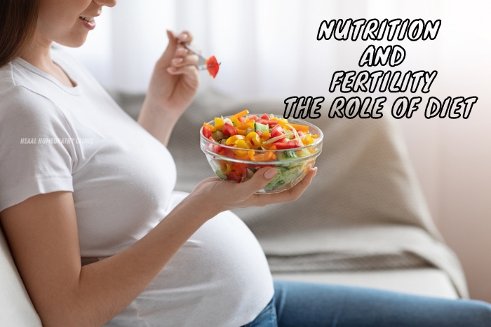 Pregnant woman holding a bowl of fresh salad, highlighting the importance of nutrition and diet in fertility, promoted by HEAAL Homeopathy Clinic in Chanda Nagar, Hyderabad