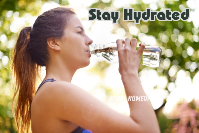 Young woman staying hydrated by drinking water outdoors - HEAAL Homeopathy Clinic in Chanda Nagar, Hyderabad promotes hydration for overall health and wellness. Natural lifestyle tips and homeopathic treatments for optimal well-being