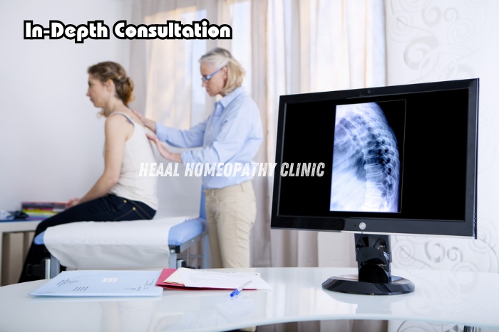 HEAAL Homeopathy Clinic in Chanda Nagar-A doctor conducting a detailed spine check-up during an in-depth consultation for back pain